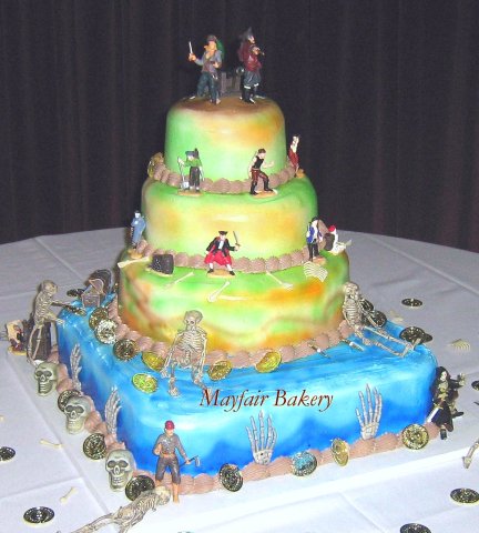 4 tier pirates theme - 4-tiered pirate-themed wedding. The ushers were all dressed as pirates and the bridesmaids as wenches.7&quot;, 10&quot;, 12&quot; rounds on a 16&quot; square. 25 to 28 pounds. Serves 125 to 140.It took multiple coats of airbrush to decorate this with drying time in between.&amp;nbsp;Iced with vanilla buttercream and chocolate buttercream borders.